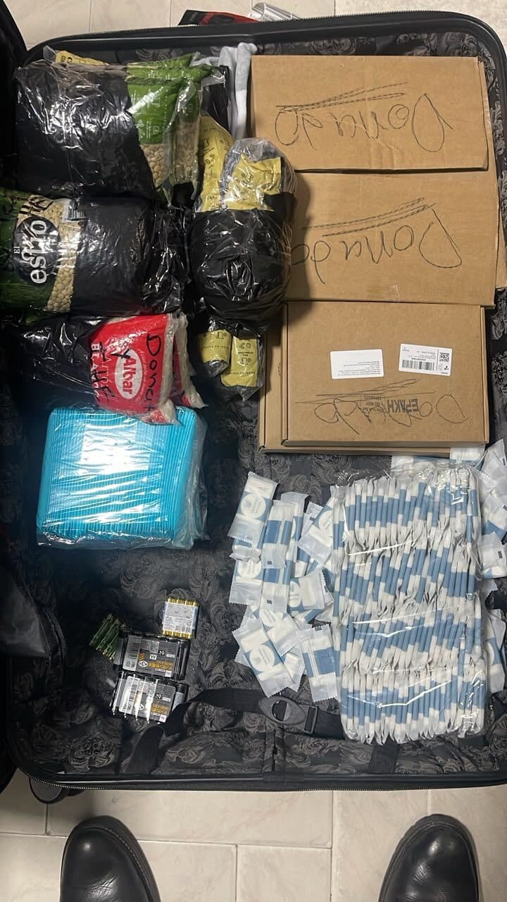 Suitcase packed with donated food staples, toothbrushes and batteries prepared for the humanitarian mission to Venezuela.