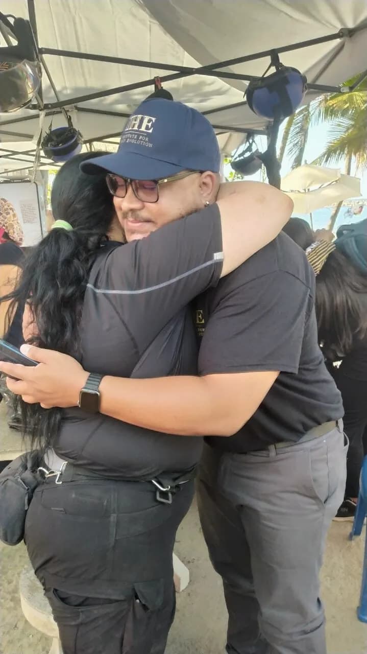 Two IHE team members embrace at the camp in La Guaira